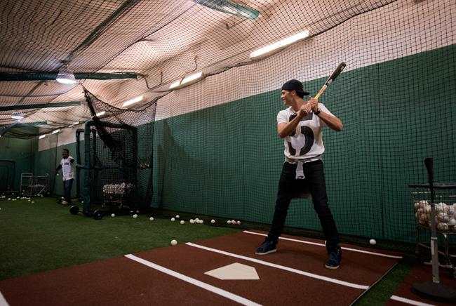 Tom Brady, who was at Fenway Park on Opening Day 2015 to throw out a ceremonial first pitch, takes BP with former Red Sox ace Pedro Martinez before the game.
